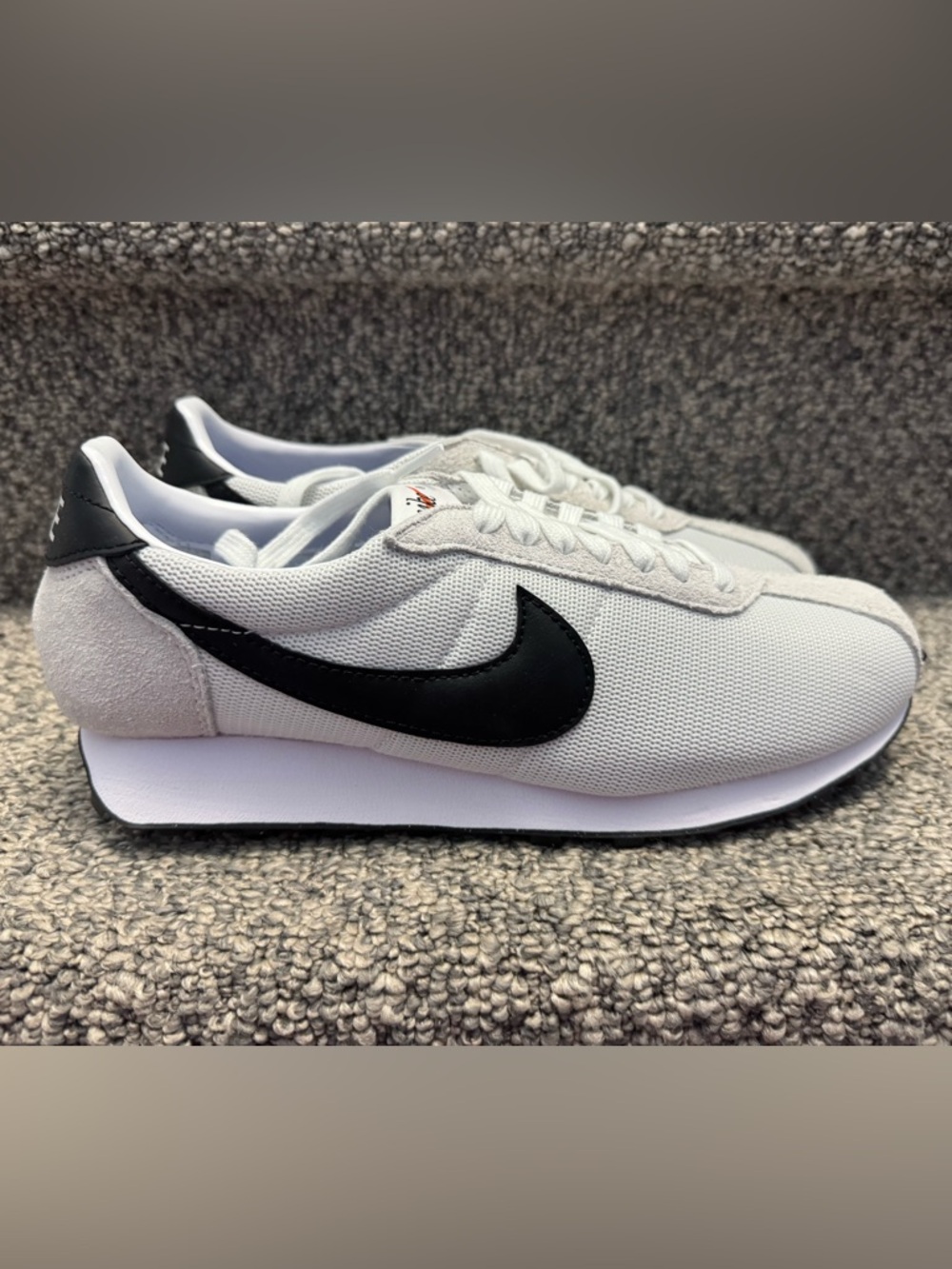 Nike women's White Sneakers with Black Swoosh size 11. Never worn.